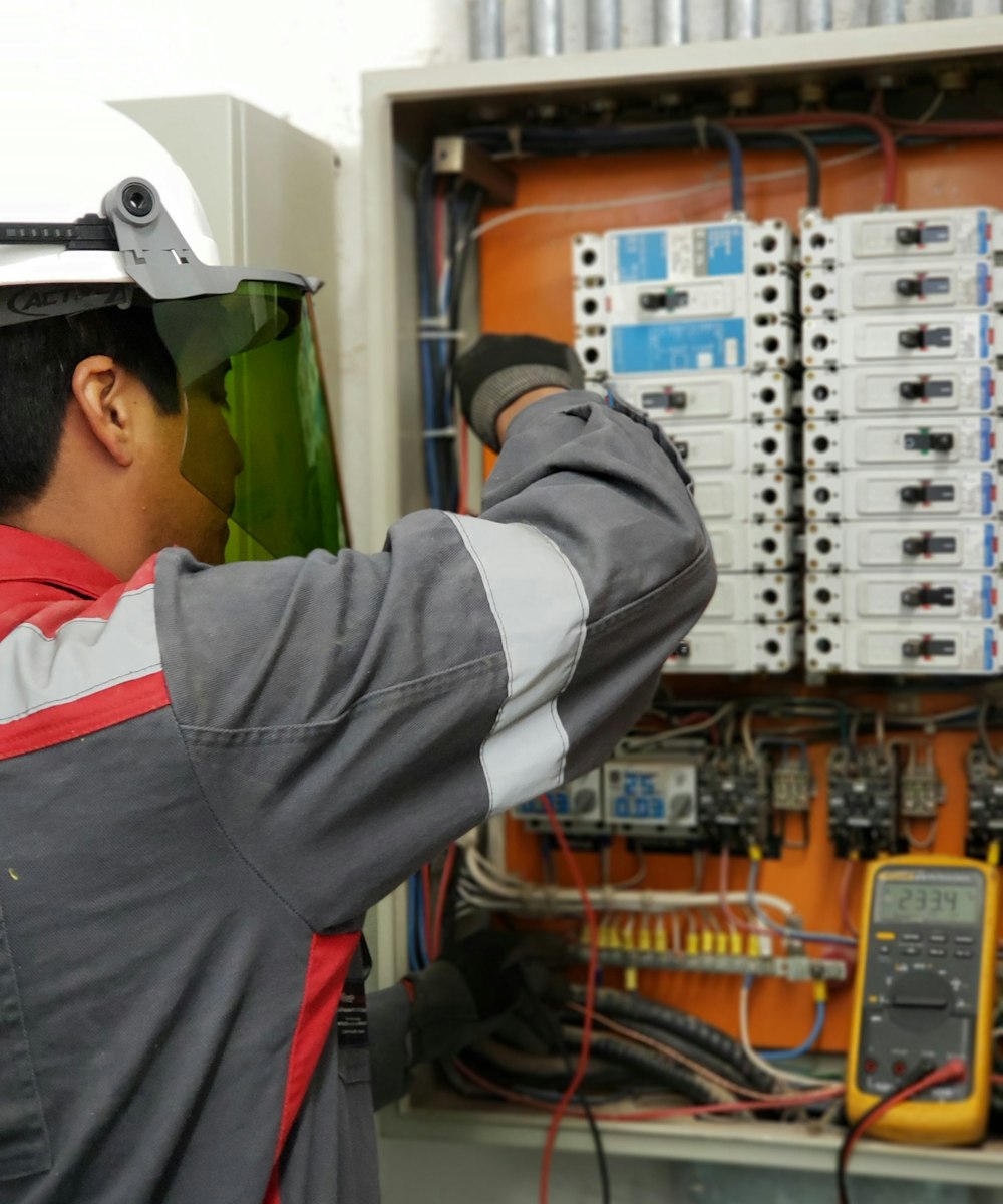 Elite Air technician running diagnostics on an HVAC electrical panel
